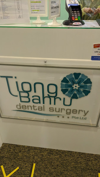 Tiong Bahru Dental Surgery reception counter with logo